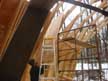I used 1/2 inch plywood on the sides and 5/8 for the roof. Here I am raising a 5/8 sheet as high as possible. I would then prop it on the ladder. After climbing onto the scaffoldiing I would pull the sheet off of the ladder and then push it onto the roof. 